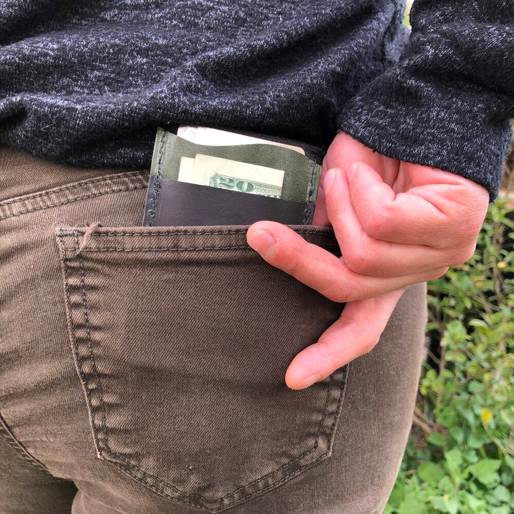 "Just the Essentials" Leather Card Wallet in back pocket holding cash and cards