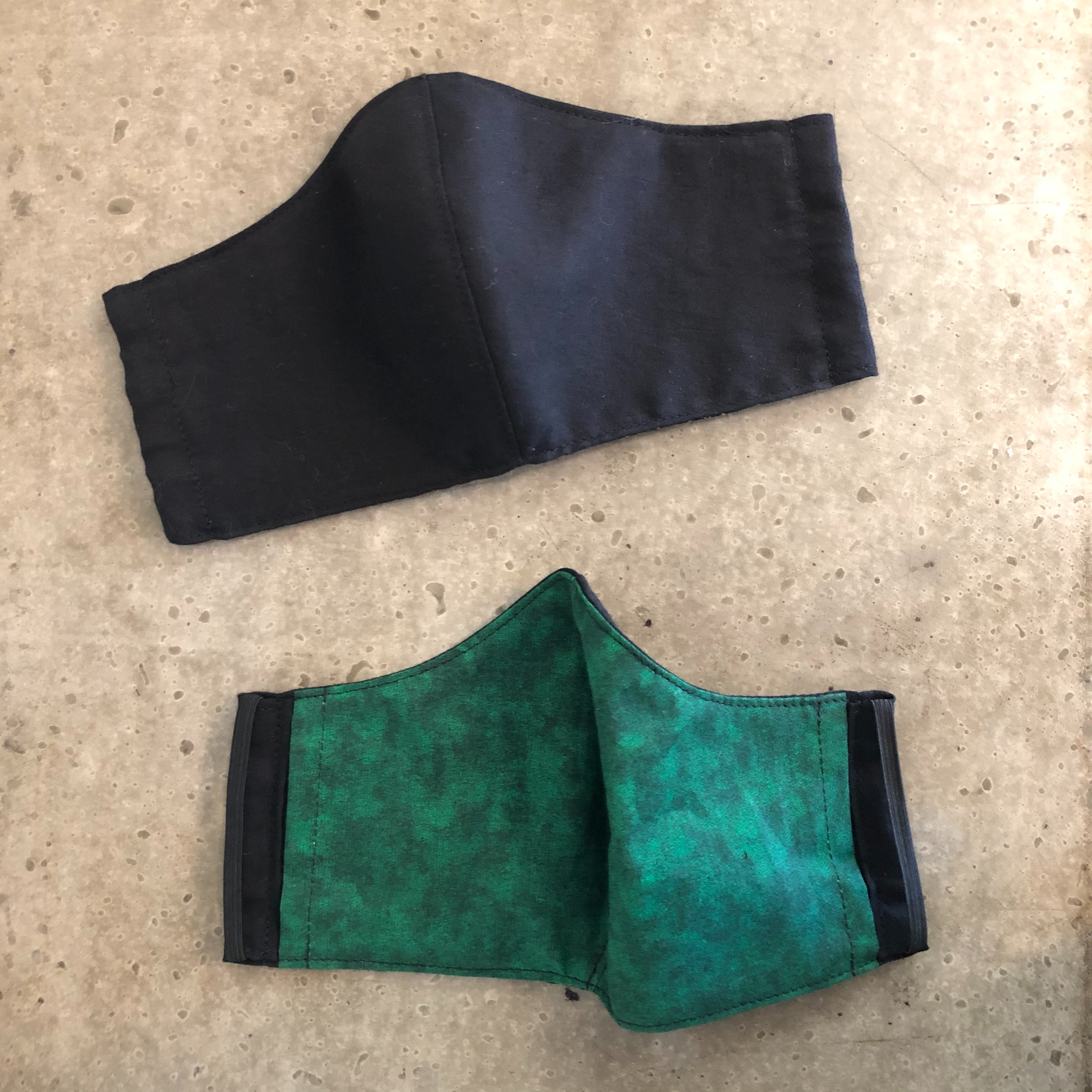 black face mask with green inside view of inside and outside