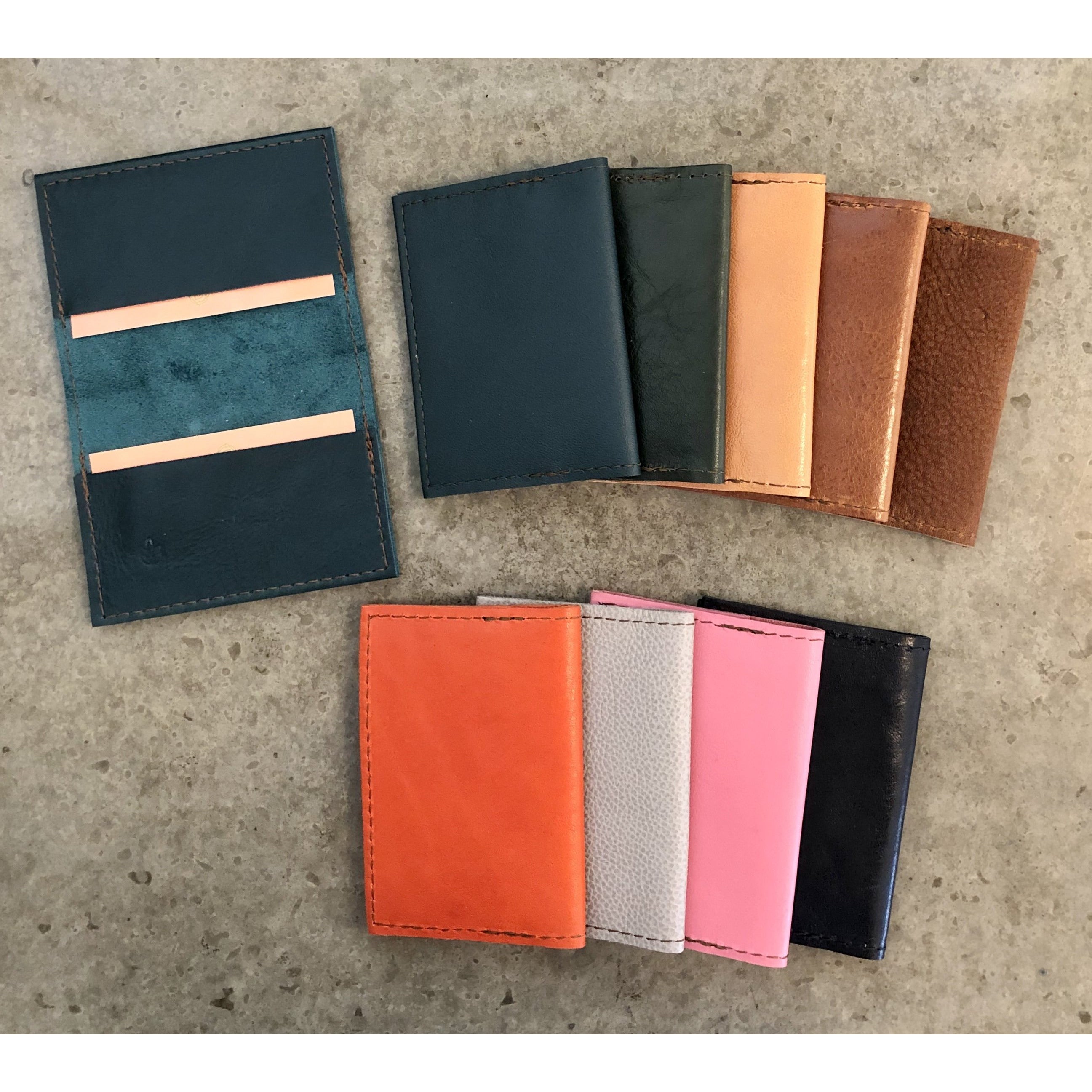 Leather Slimfold Wallets, current color offerings: Shiny Teal, Teal, Forest Green, Light Tan, Brown, Suede Brown, Bright Orange, Spotted Off White, Bubblegum Pink, and Black